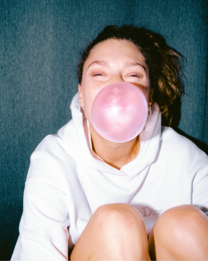 Person blowing a bubblegum bubble