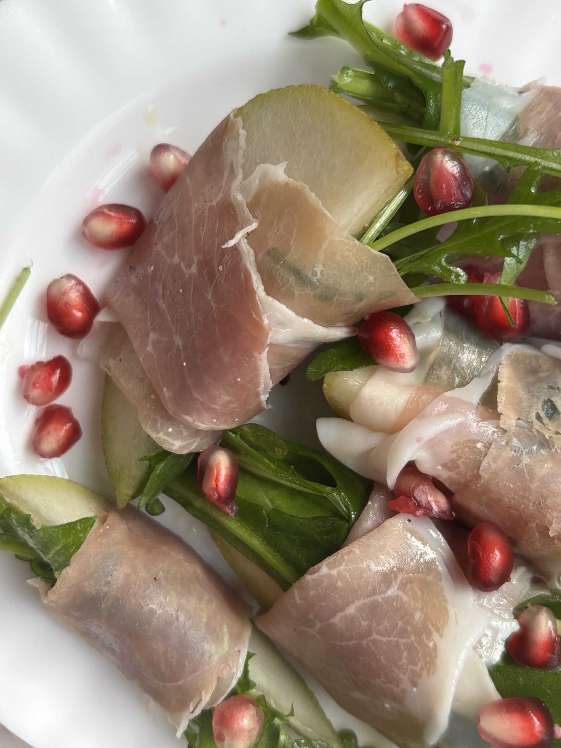 Close-up image of cucumber and prosciutto salad