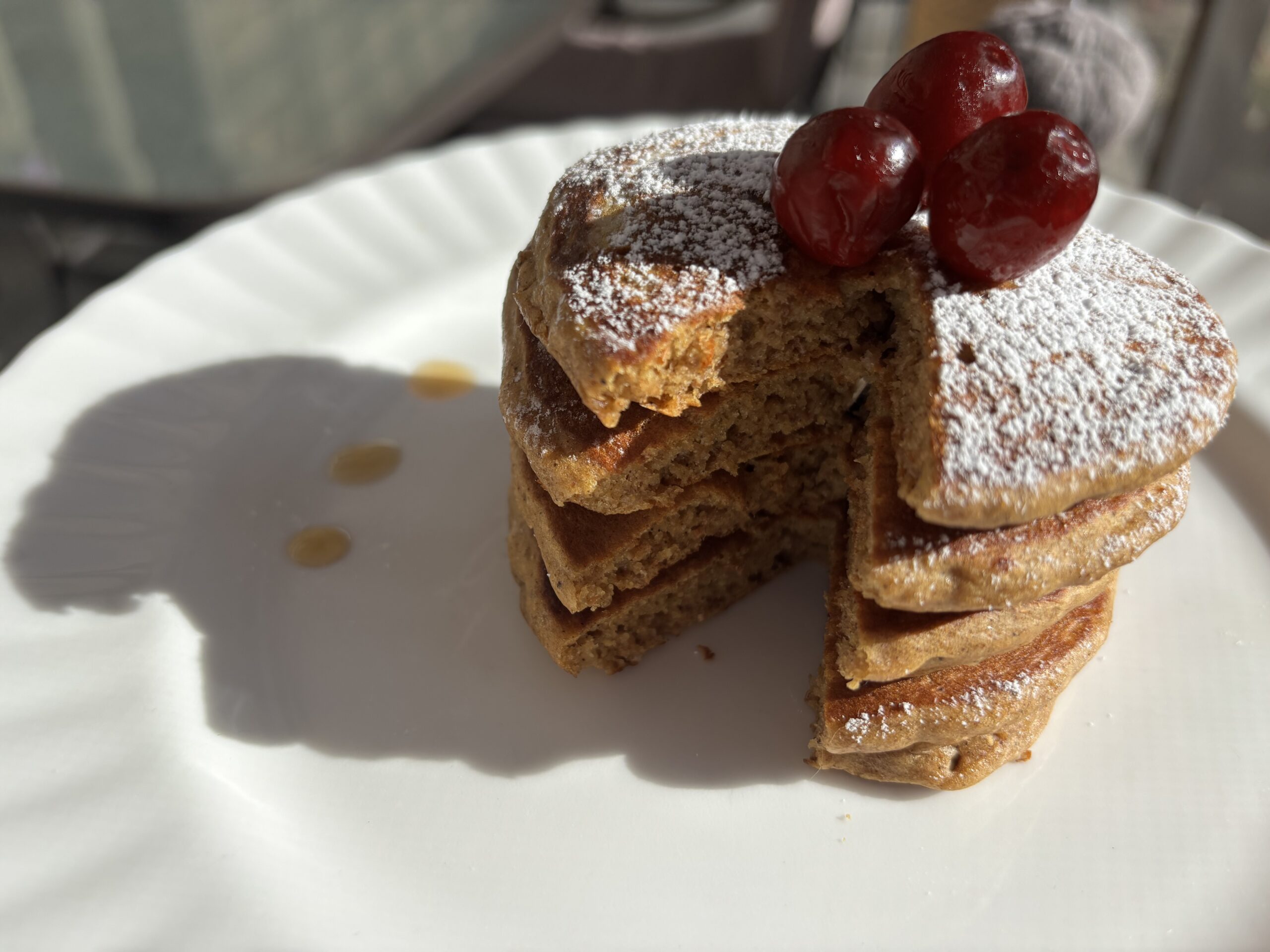 stack of pancakes with icing sugar dusted on top