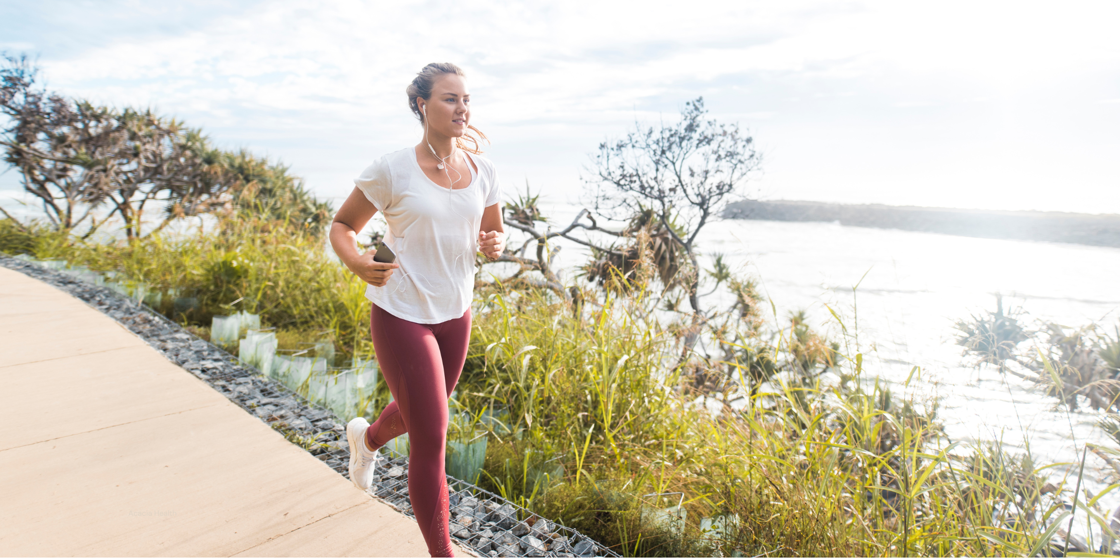 Woman running by the ocean