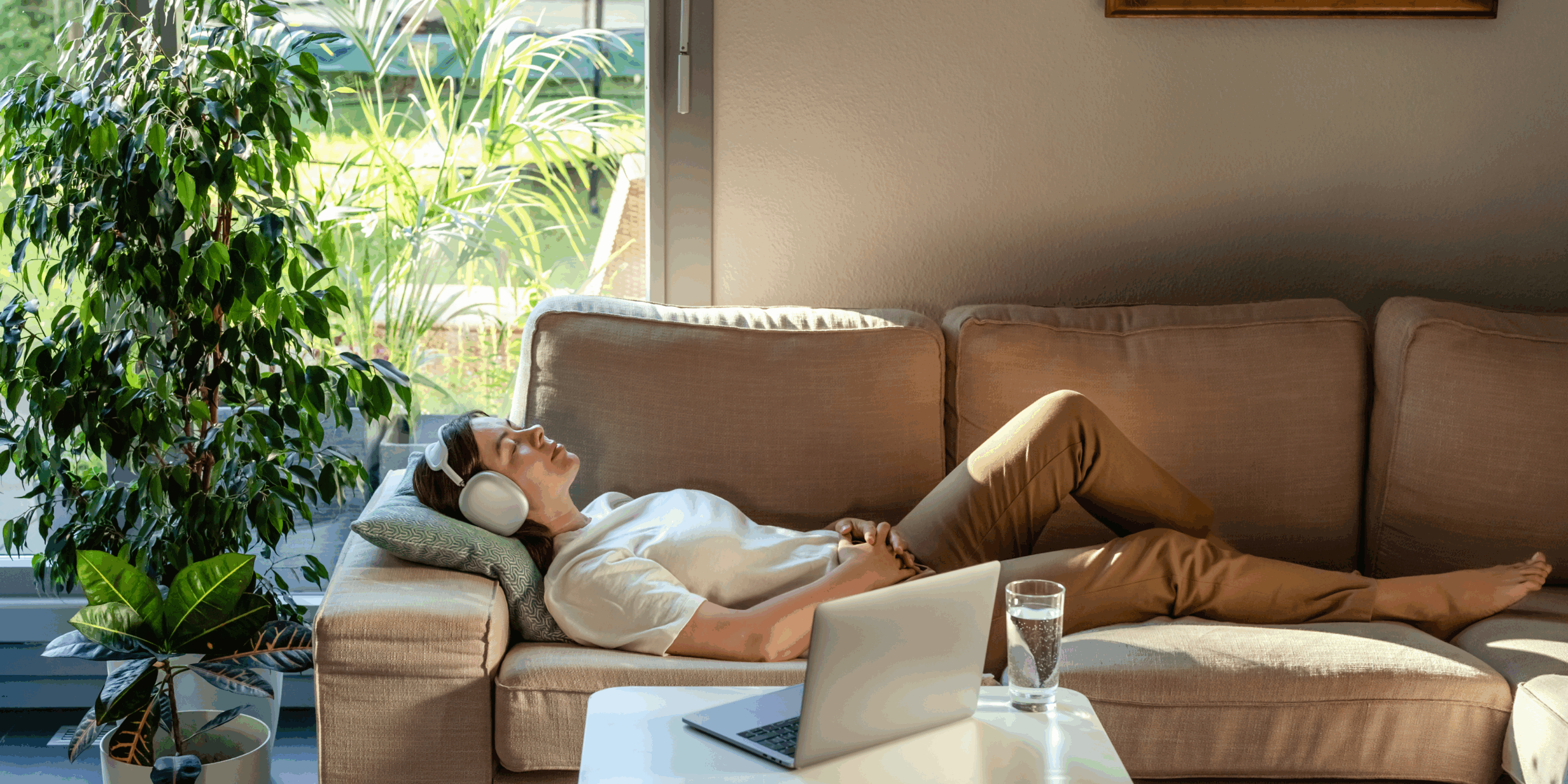 Woman lying on a couch with headphones on