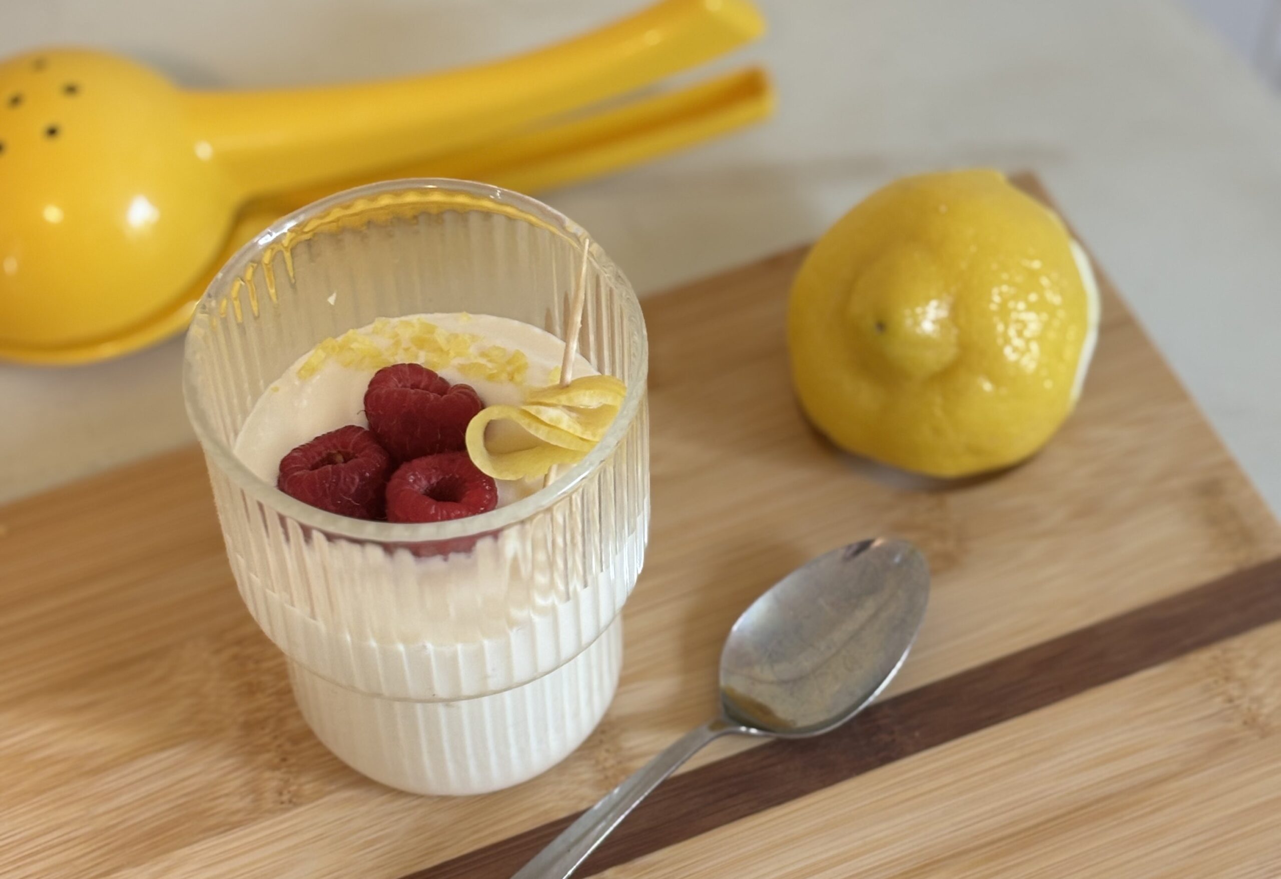 Tofu pudding in a cup with raspberries