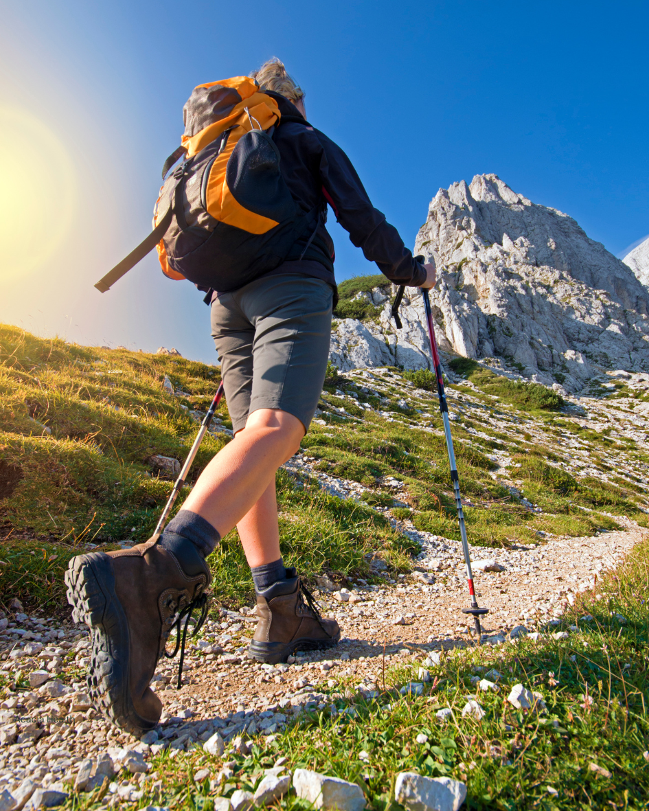 woman hiking up a mountain