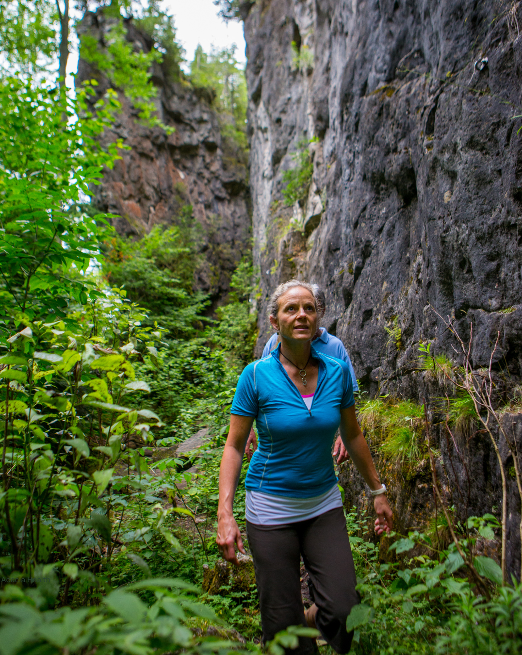 Elderly woman hiking in the forest