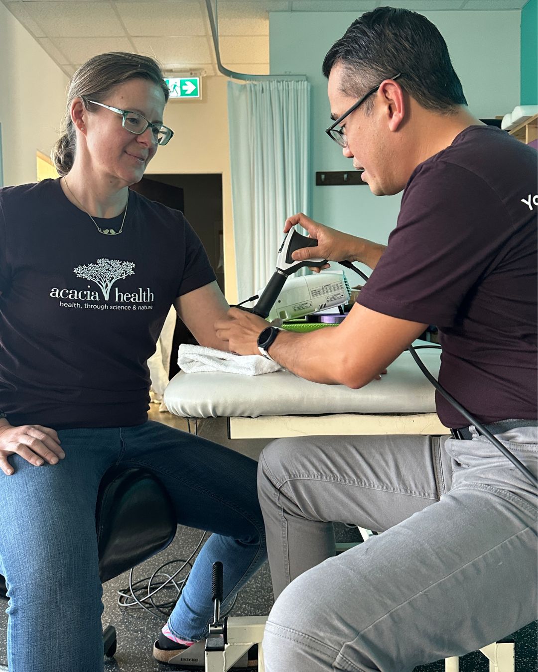 Mel providing shockwave therapy to a patient