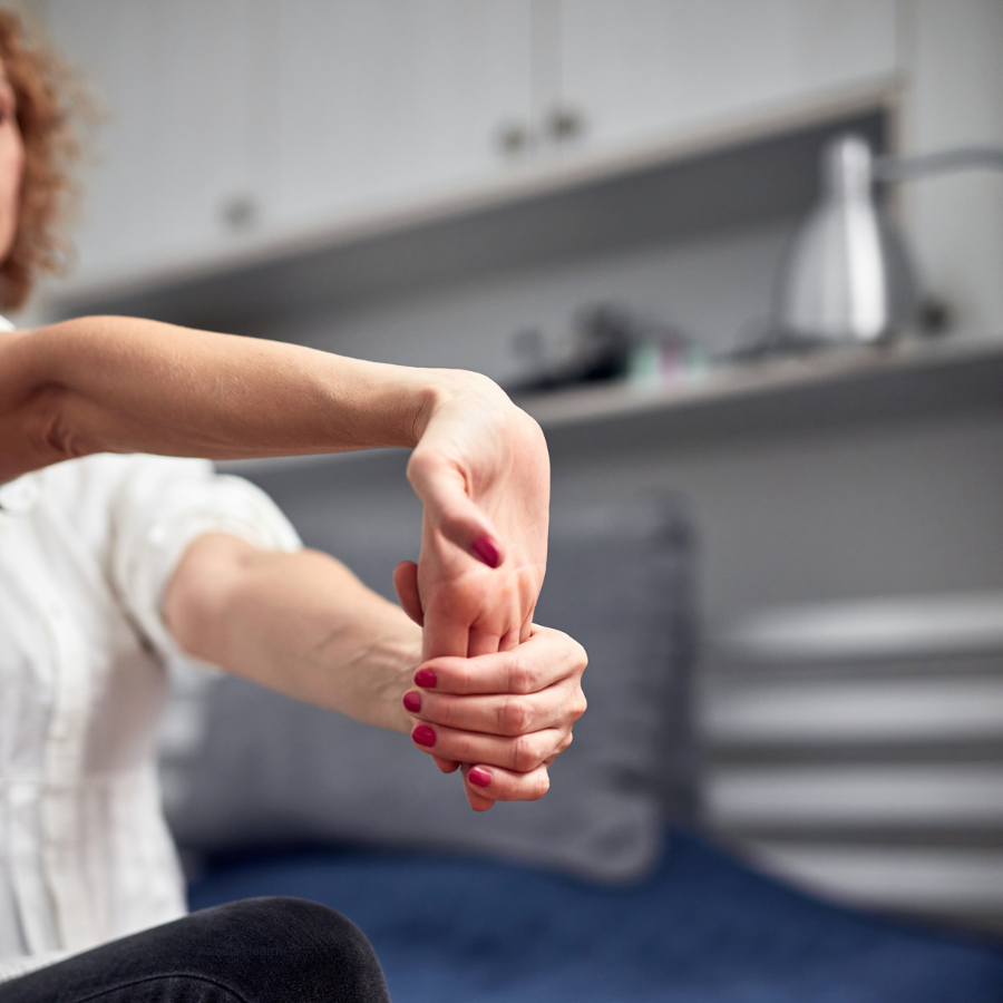 Arms outstretched with one hand pulling back on fingers to stretch the other arm
