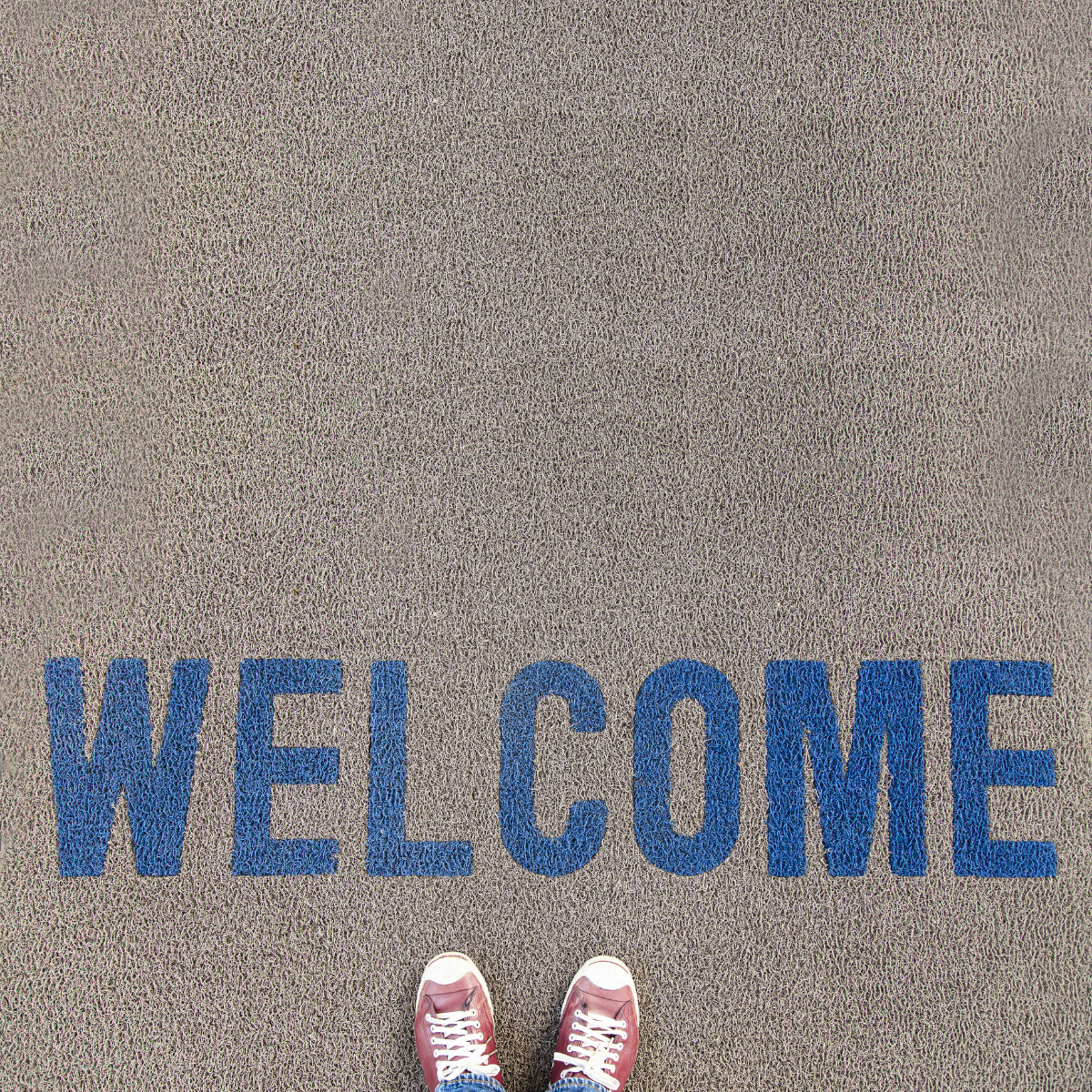 The word welcome spray painted on the asphalt.