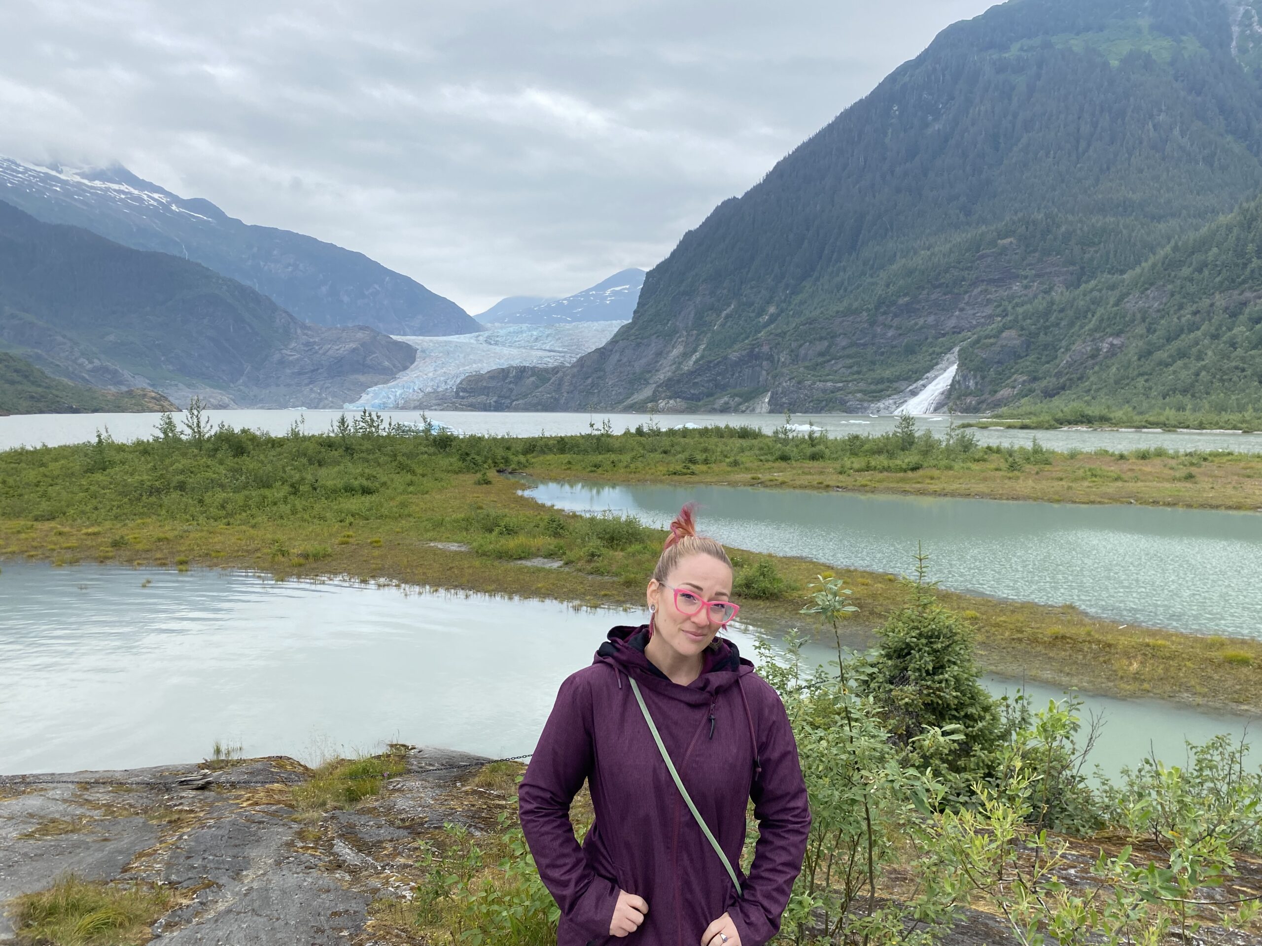 Kim standing beside lake and glacier