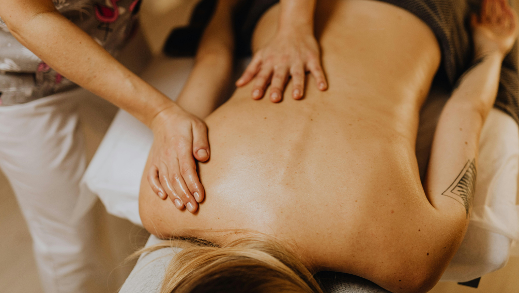 Person on massage table getting a back massage