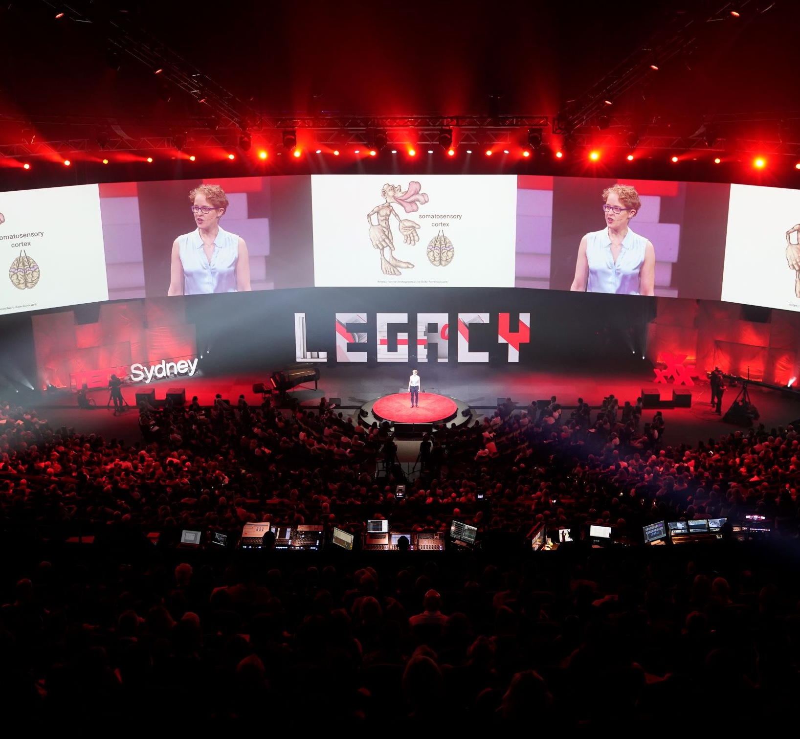 Woman speaking in front of a large audience