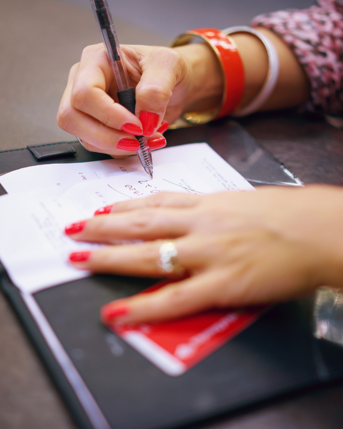 Woman signing the check at a restaurant