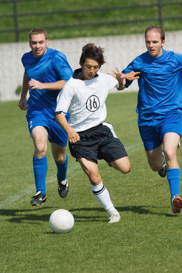 Football players competing for the ball