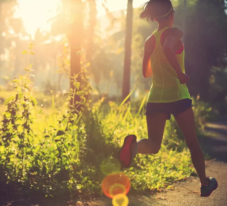 Woman trail running in the forest