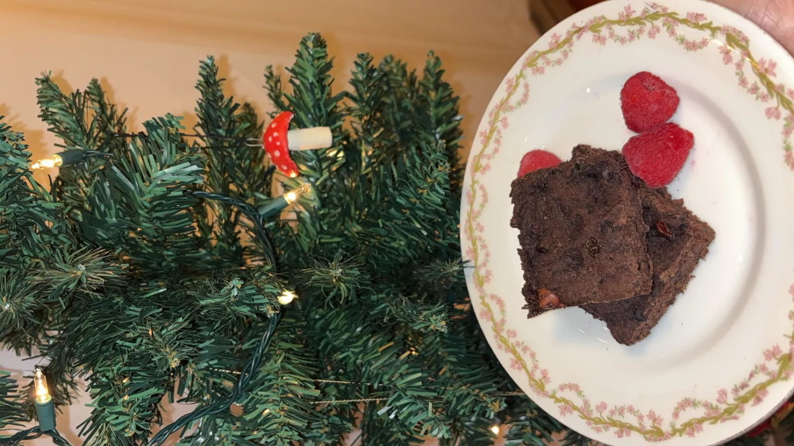 Brownies on a plate, next to a christmas tree