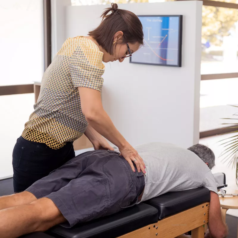 Chiropractor giving a lower back adjustment