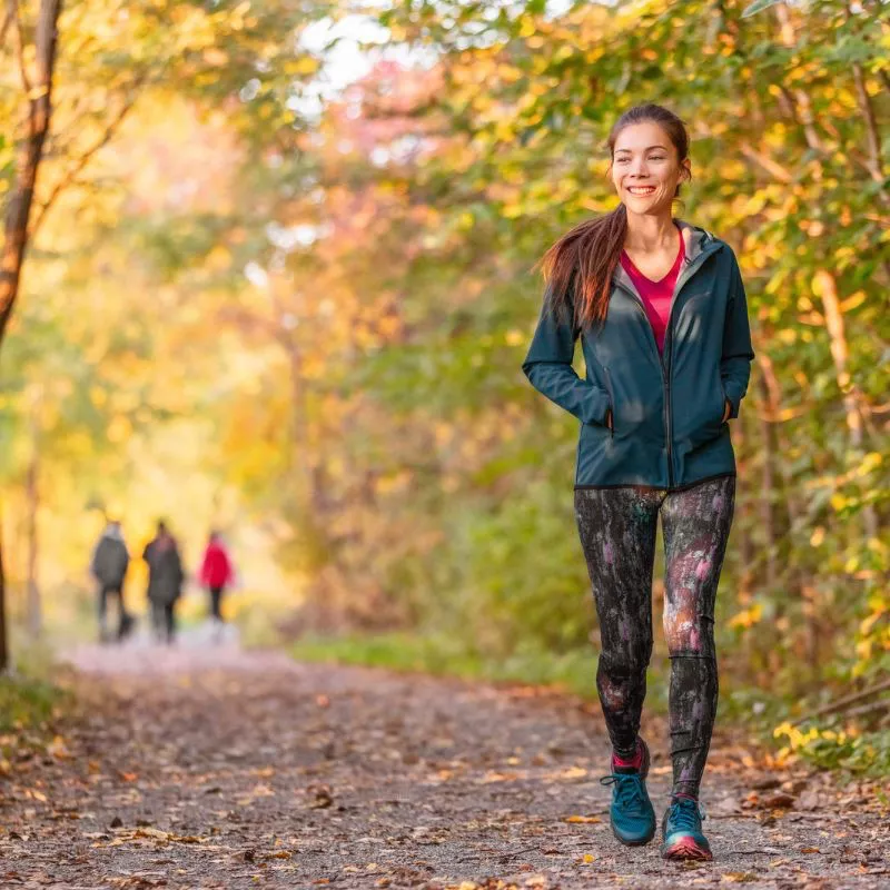 Woman out for a walk in a forested park