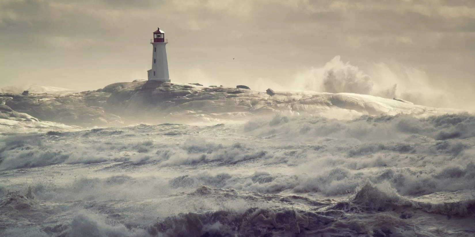 Lighthouse with crashing waves all around it