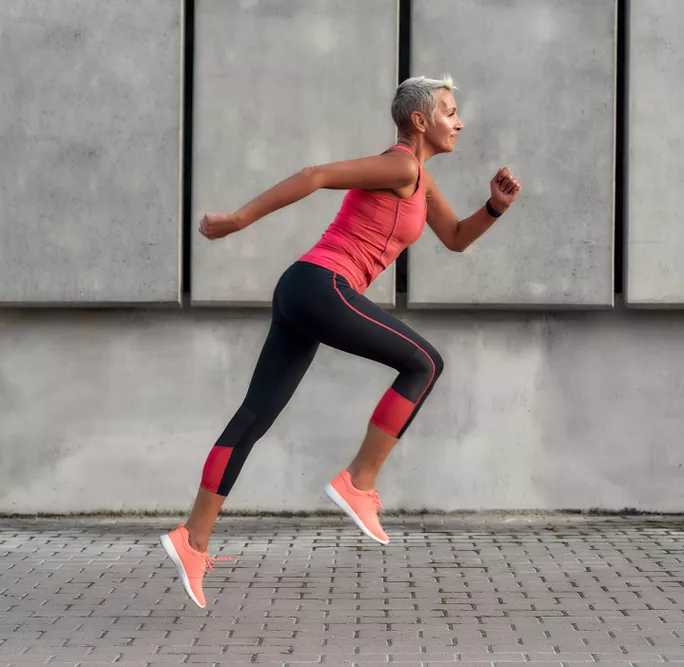 Woman running with both feet off the ground