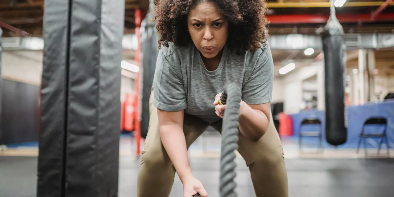 Woman working out with ropes in the gym