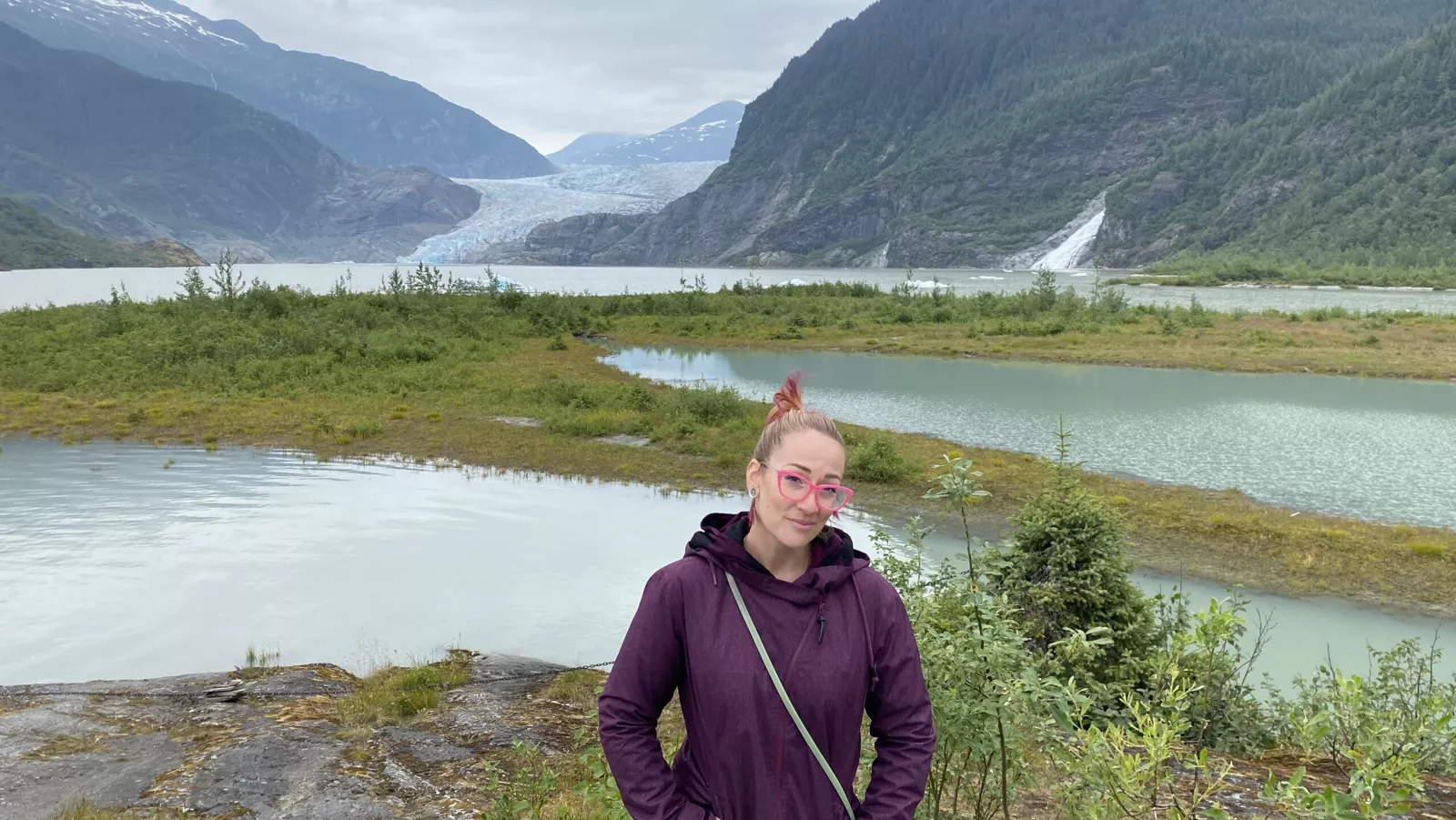 Kim standing beside lake and glacier