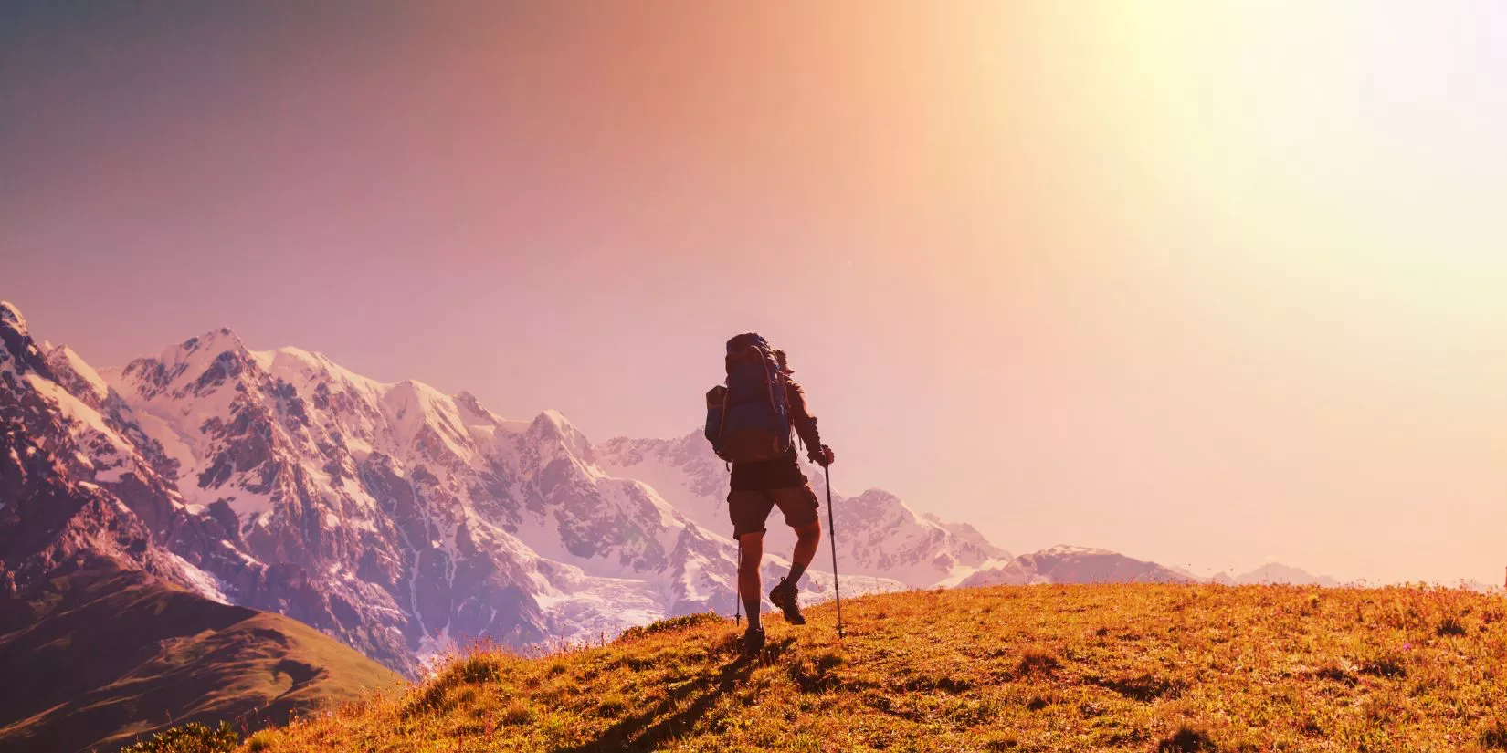 Person hiking into the sunset