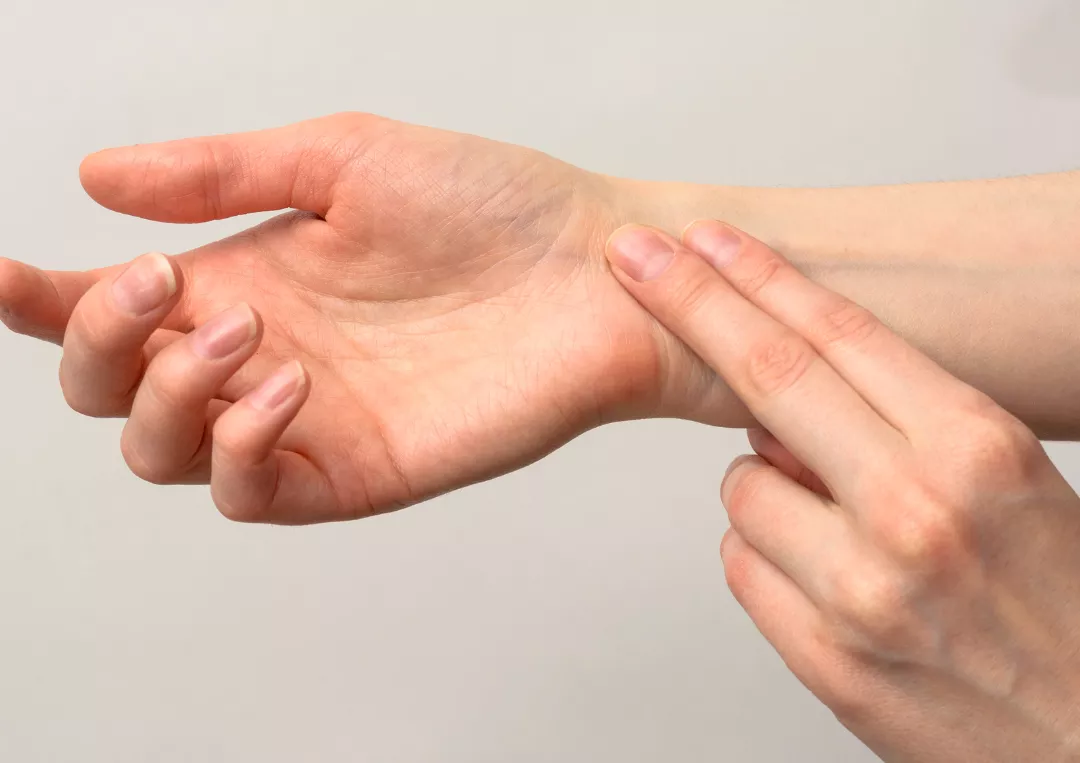 Someone checking their pulse at the wrist