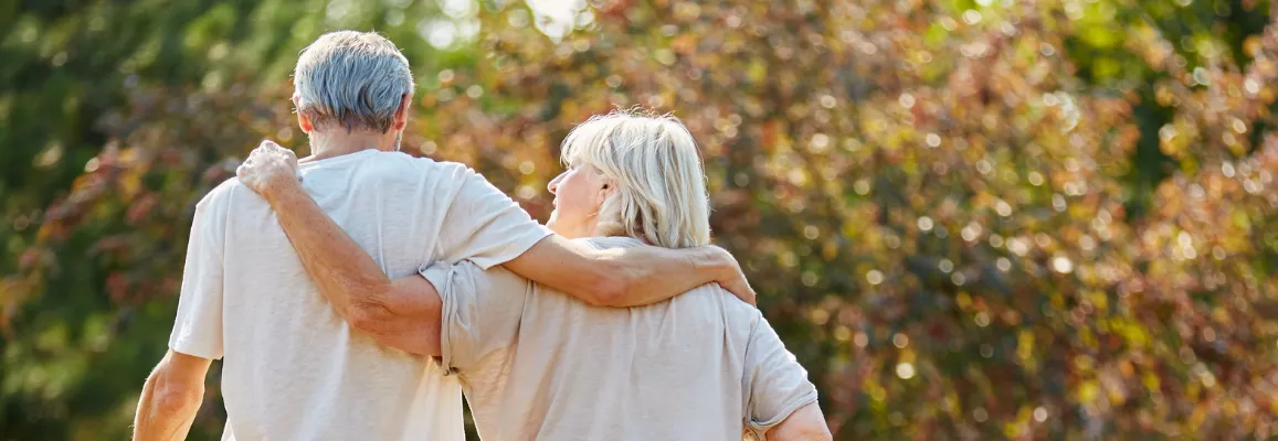 Senior couple walking through the park