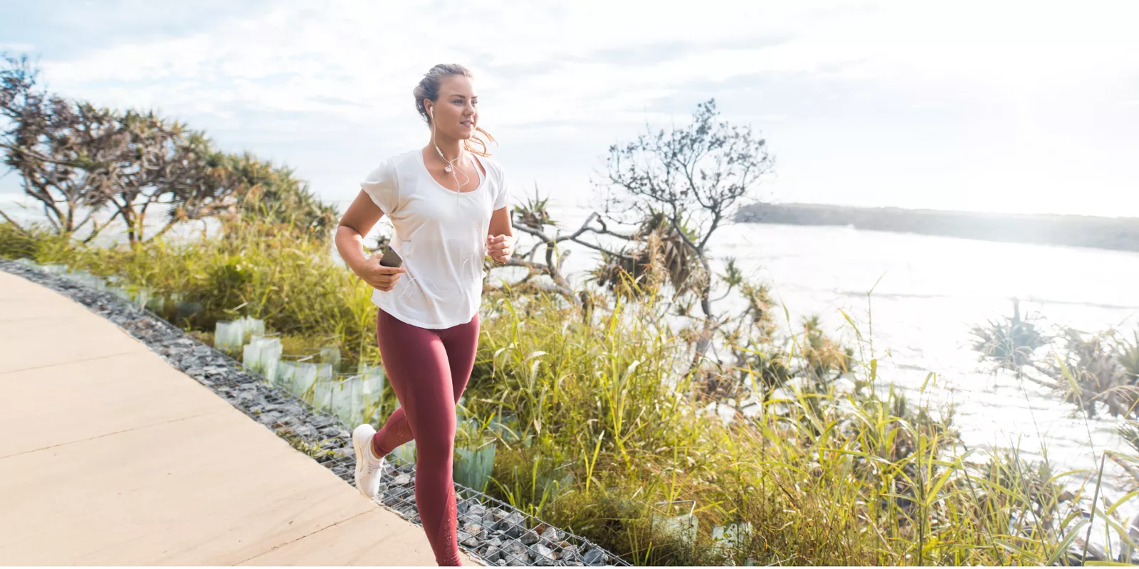 Woman running along the coast
