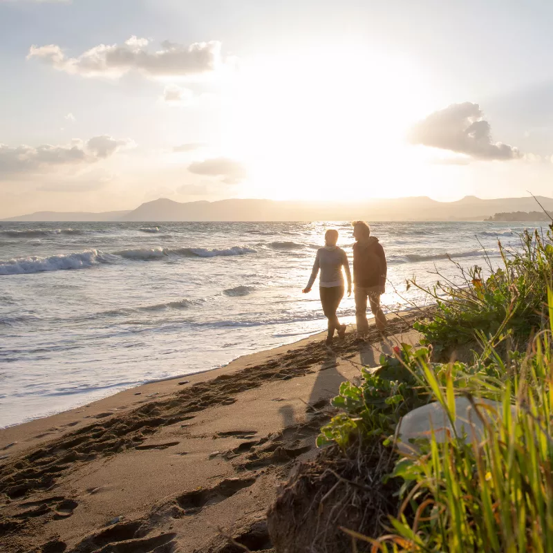 Couple walking down the beach