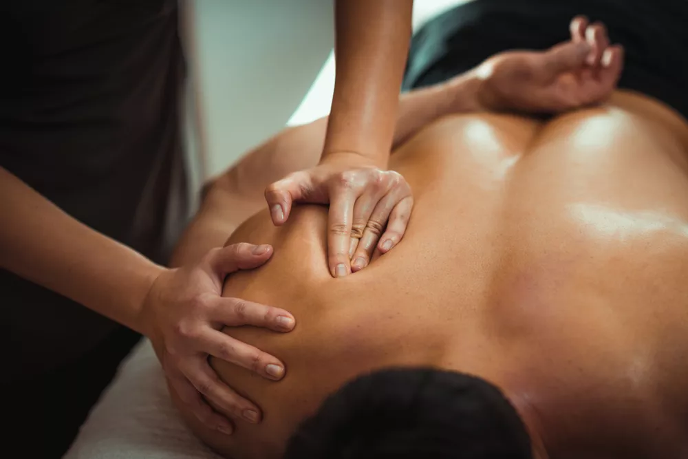 Massage Therapist massaging a patient's back