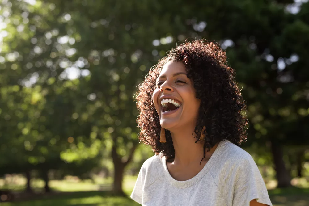 Woman laughing in trees