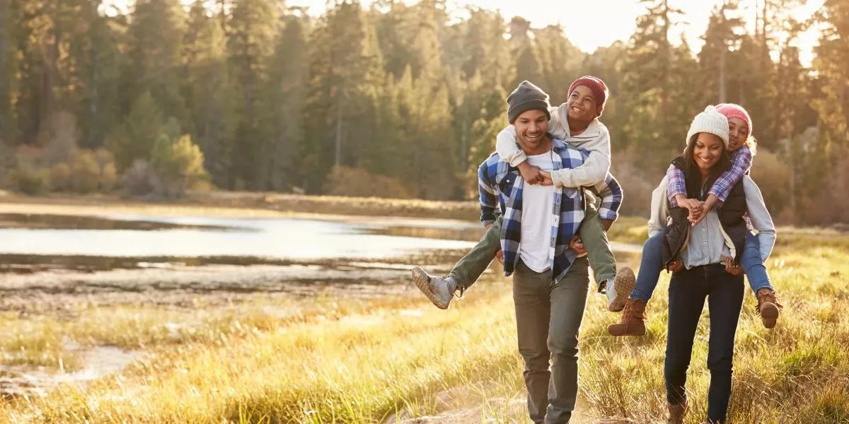 Family hiking by a river