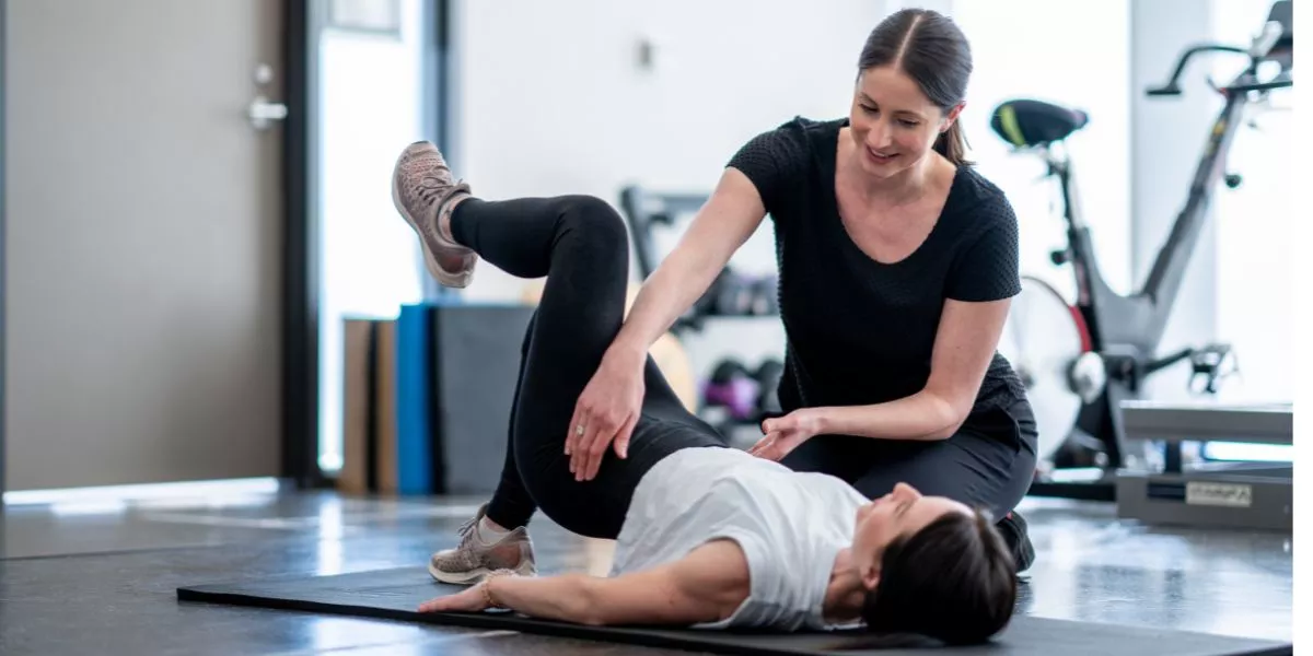 Therapist helping with pelvic exercises