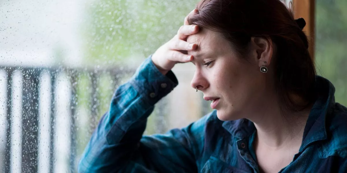 Woman in distress near the window