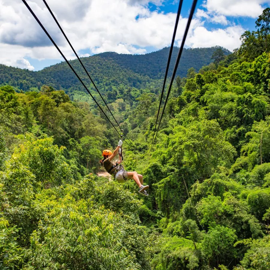 Woman riding zipline in the forest