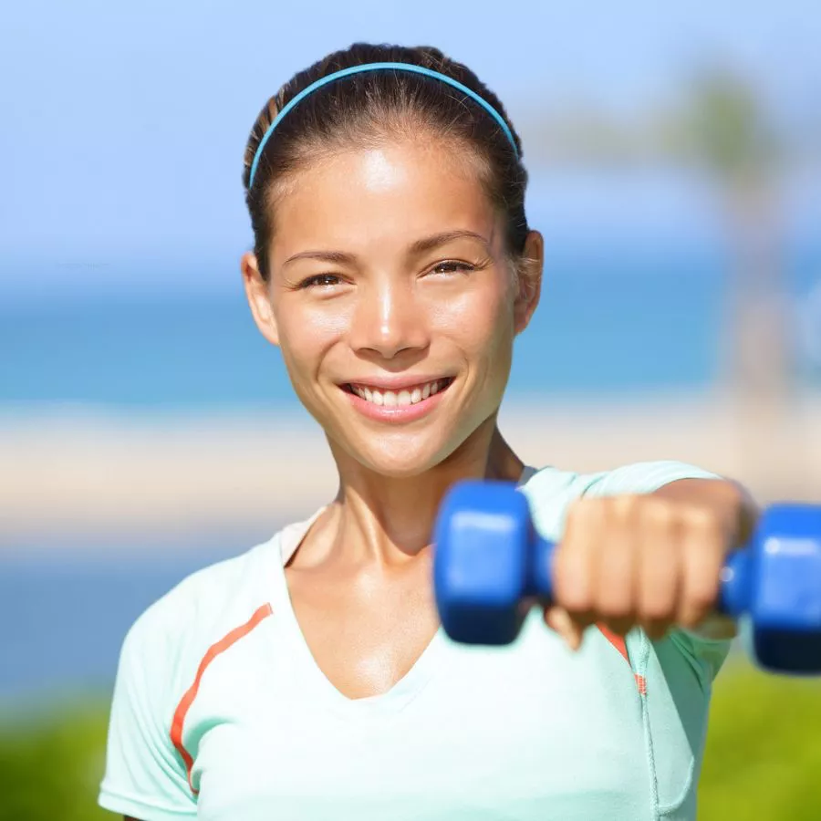 Woman holding a weight at shoulder height
